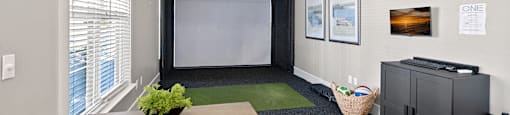 A room with a table, chairs, and a projector.