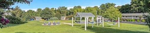 a park with a playground and a swing set