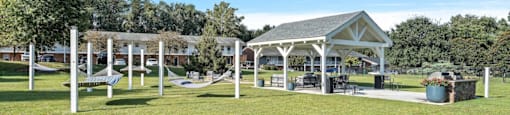 a group of hammocks and a pavilion in a park