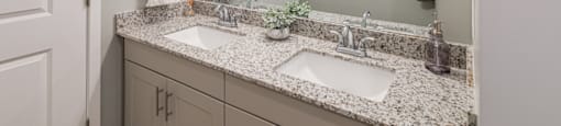 a bathroom with two sinks and a large mirror
