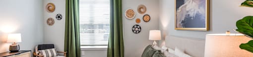 bedroom with a large bed and green curtains and a ceiling fan