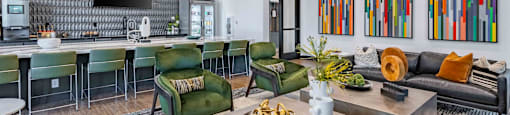 a living room with a kitchen and a table with chairs