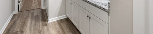 a bathroom with granite counter tops and a large mirror