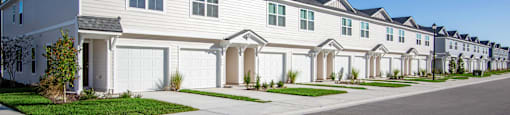 A row of houses with a street in front.