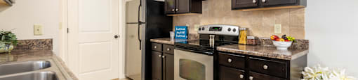 modern kitchen with dark brown cabinetry and stainless steel appliances