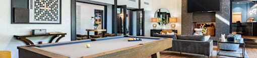 a pool table in a living room with a tv