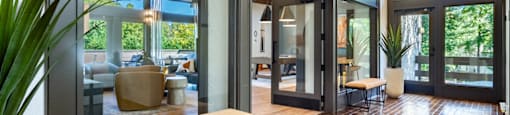 a lobby with glass doors and a bench