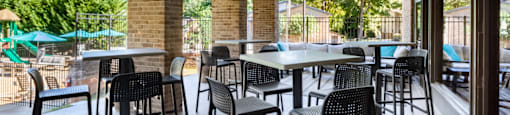 an outdoor patio with tables and chairs at a restaurant