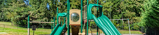 a playground with two slides at a park