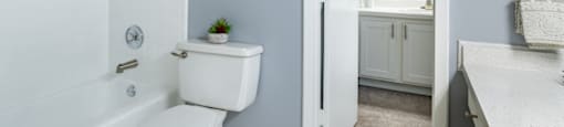 a bathroom with a toilet and a tub and a sink