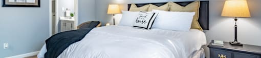 a bedroom with a large white bed and blue walls