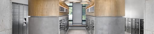 A modern hallway with wooden ceilings and concrete columns.