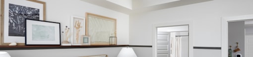 A bedroom with a bed, nightstand, and a ceiling fan.