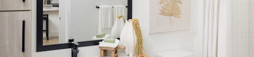 A bathroom with a white toilet, sink, and wooden cabinets.