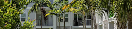 A white building with a walkway in front of it.