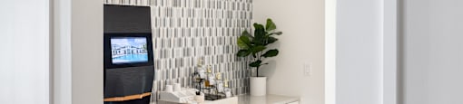 A kitchen with white cabinets and a tiled backsplash.
