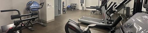 a gym with weights and other exercise equipment in a building