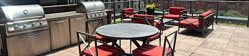 a patio with a table and chairs on a rooftop