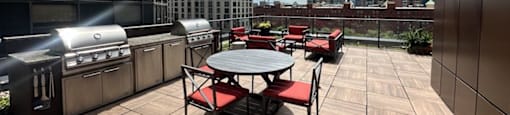 a patio with a table and chairs and a city in the background