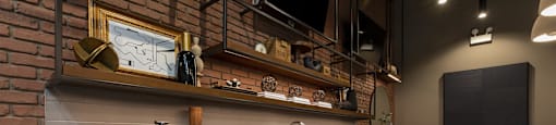 A modern kitchen with wooden cabinets and a brick wall.