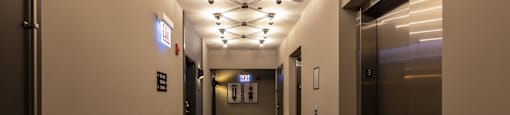 A long hallway with a series of lights on the ceiling.