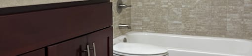 A bathroom with a toilet, sink, and shower.