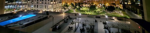 a view of the city at night from a rooftop terrace