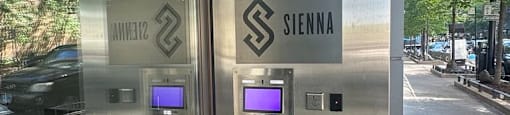 the front of a sigma building with a fern in front of the door