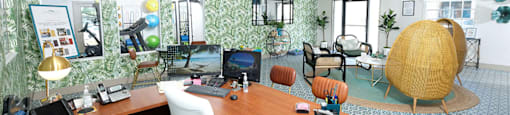 Watermarq Apartments Clubhouse in Lakeland, Fl with large leasing desk, modern lighting, and tropical palm wallpaper accent wall.