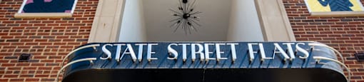 A sign that says State Street Flats