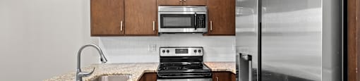 State Street Flats Apartments near Vanderbilt campus kitchen with a stove, oven, and refrigerator.