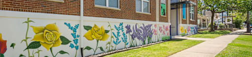 State Street Flats Nashville 1 bedroom apartments - brick building with a mural of flowers painted on the wall.