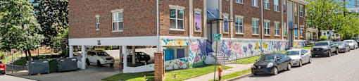 A street view of State Street Flats Apartments with a mural on the side - Nashville downtown apartments.