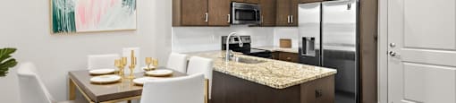 State Street Flats Apartments near Vanderbilt University Nashville TN modern kitchen with a dining table set for two.