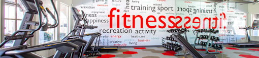 A gym with treadmills and a sign that says "fitness recreation activity".