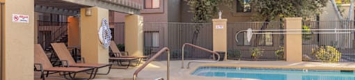 A pool with a slide and a hot tub.