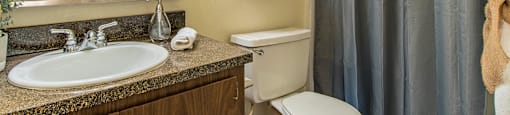 Cottonwood Creek bathroom with brown cabinetry.
