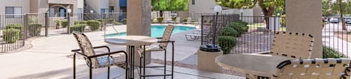 Seating under ramada with pool in background