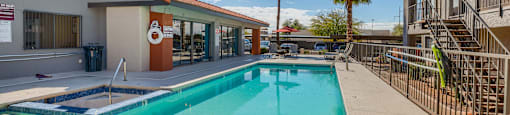 A swimming pool in a sunny outdoor setting.