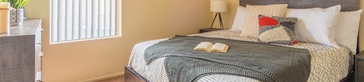 Enclave bedroom with natural lighting and ceiling fan