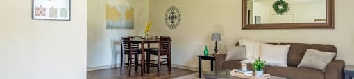 The Springs living room with carpet flooring and ceiling fans