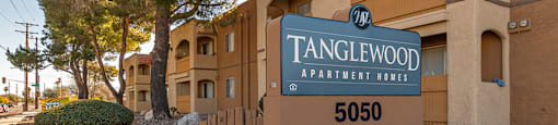 Tanglewood community sign with well kept entrance and flowers all around
