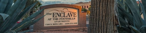 Enclave community sign near well kept entrance