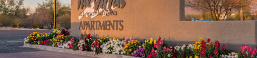 villas at Montebella community sign with pretty flowers planted around