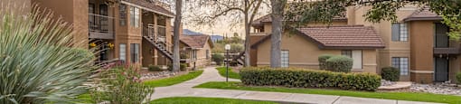 Arboretum view of apartments with lush landscape