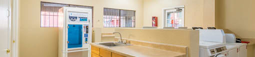 Laundry room with sink and water jug dispenser