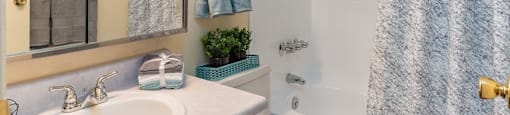 Cottonwood Creek bathroom with brown cabinets and white walls.