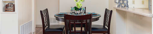 Cottonwood Creek dining room with cream colored walls and a dark brown dining table set.