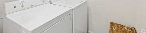 A white washer and dryer in a small laundry room.