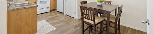 A kitchen with a table and chairs in the middle of the room.